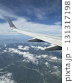 飛行機の翼と雲海を上空から眺めた風景 | Aerial View of Airplane Wing  131317198
