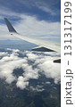 飛行機の翼と雲海を上空から眺めた風景 | Aerial View of Airplane Wing  131317199