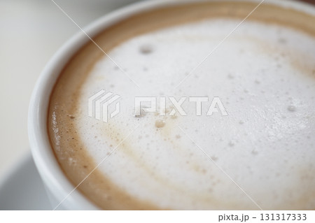 Delicious foamy coffee served in a white cup Delicious foamy coffee served in a white cup 131317333