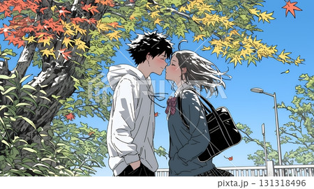 秋の紅葉の下でキスをしている若い恋人たち秋の紅葉の下でキスをしている若い恋人たち
