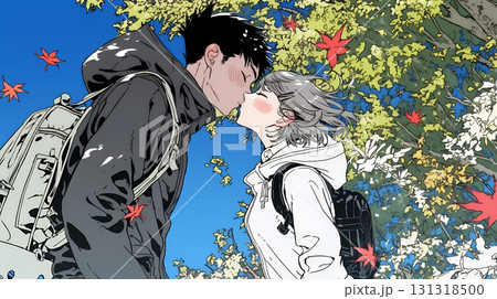秋の紅葉の下でキスをしている若い恋人たち