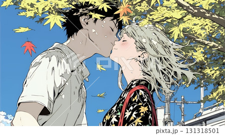 秋の紅葉の下でキスをしている若い恋人たち