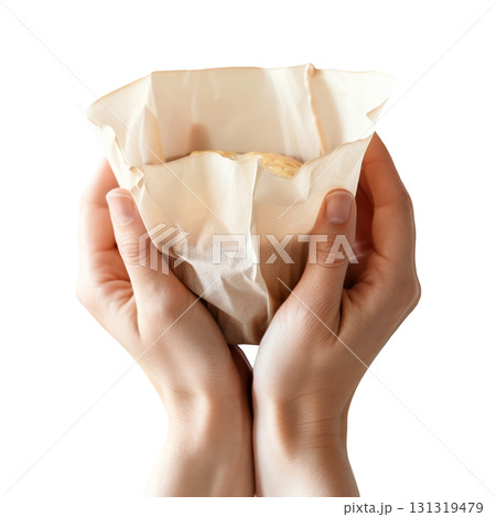 Close-up of hands holding a cupcake wrapped by white parchment paper, isolated on a transparent background. 131319479