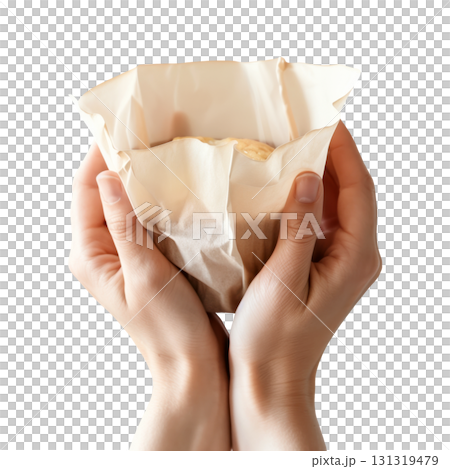 Close-up of hands holding a cupcake wrapped by white parchment paper, isolated on a transparent background. 131319479