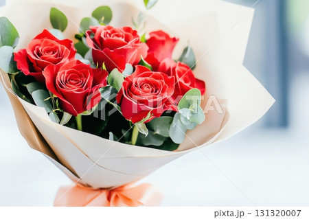 Deep red roses beautifully wrapped in soft beige paper with a peach ribbon create a warm and romantic atmosphere, ideal for anniversaries, celebrations, or special gestures of love. 131320007