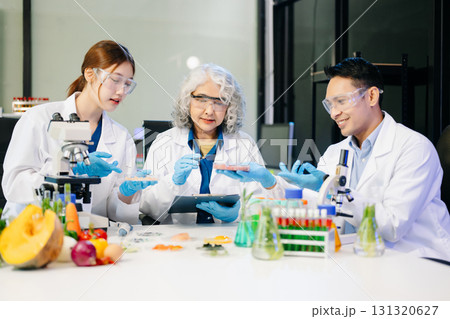 Food scientists in lab coats, testing samples, and analyzing food safety and quality in a modern laboratory Food scientists in lab coats, testing samples, and analyzing food safety and quality in a modern laboratory 131320627