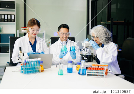 Dynamic science lab where a team of scientists collaborates on research, testing, and innovation 131320687