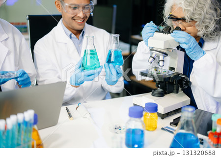 Dynamic science lab where a team of scientists collaborates on research, testing, and innovation 131320688