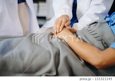 Hospital Ward Male and  Male Professional Asian Doctors Talk with a Patient, Give Health Care Advice, 131321145