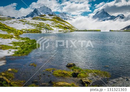 Bachalpsee lake and misty snowy mountains in background, Grindelwald, Switzerland 131321303