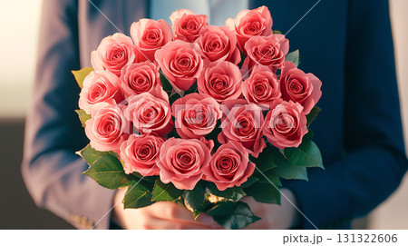 man surprises his partner with bouquet of pink roses, expressing love 131322606