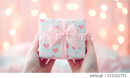 beautifully wrapped gift with heart patterned paper and pink bow beautifully wrapped gift with heart patterned paper and pink bow 131322751