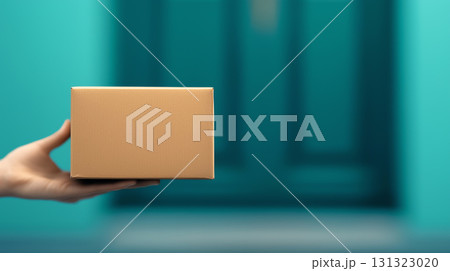 person holding brown package in front of teal door, ready for delivery 131323020