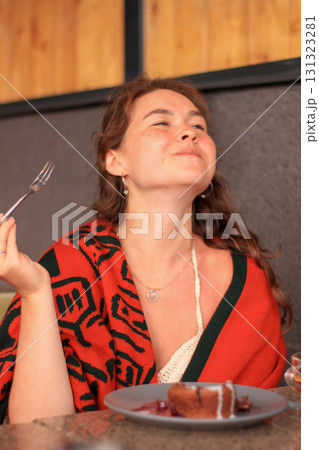 Woman enjoying dessert at restaurant 131323281