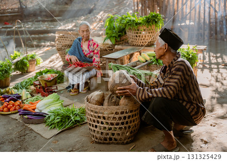 A lively market scene with fresh local produce, friendly vendors, and colorful displays 131325429