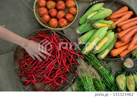 Explore a colorful array of fresh vegetables and spices available at your local market today 131325462