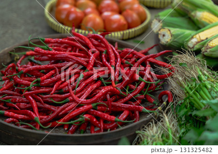 Discover the Vibrant Red Chilies and Fresh Produce Available at the Local Market Today 131325482