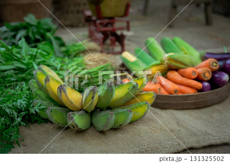 A Variety of Colorful Fresh Vegetables and Fruits Beautifully Displayed on a Rustic Surface 131325502