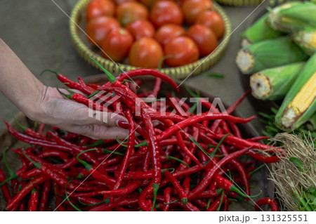 Experience the vibrant allure of Fresh Red Chilies and Tomatoes available at the Market Experience the vibrant allure of Fresh Red Chilies and Tomatoes available at the Market 131325551