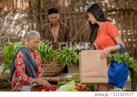 A colorful local market featuring women and elderly vendors actively engaged in community life 131325577