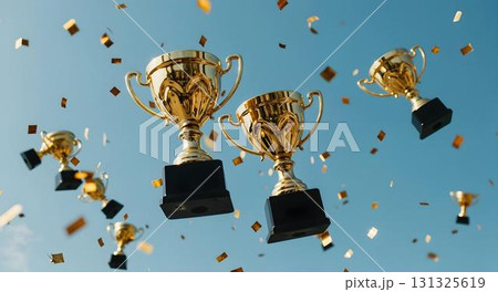 Numerous gold trophies hover above, illustrating achievement and success in an educational context, with a school themed backdrop 131325619