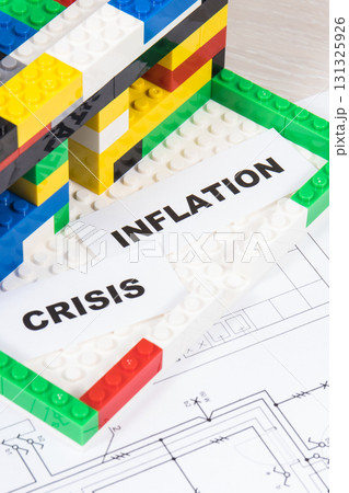 Housing plan with electric installation, house under construction made of toy blocks 131325926