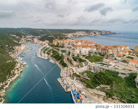 Aerial view marina cape Bonifacio south Corsica France citadel on rocky promontory on wild white limestone cliffs 131326031