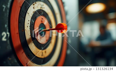 A dartboard with a dart shows the themes of success, strategy, and achievement in problem-solving 131326134