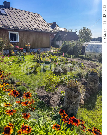 ural garden with blooming flowers, vegetables, and wooden house, summer countryside lifestyle background. High quality photo ural garden with blooming flowers, vegetables, and wooden house, summer countryside lifestyle background. High quality photo 131326213