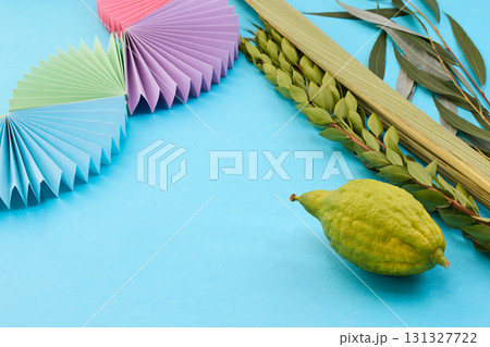 Colorful Sukkot Composition. Festive Sukkot arrangement with lulav, etrog, and vibrant paper decorations Colorful Sukkot Composition. Festive Sukkot arrangement with lulav, etrog, and vibrant paper decorations 131327722