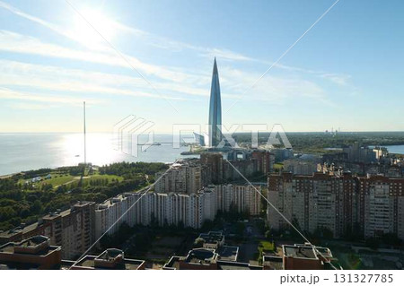 A stunning cityscape featuring a magnificent modern skyscraper alongside a beautiful seaside view A stunning cityscape featuring a magnificent modern skyscraper alongside a beautiful seaside view 131327785