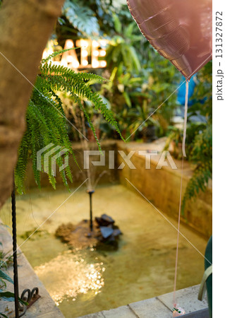 A Tranquil Garden Fountain Serene and Peacefully Surrounded by Lush Beautiful Greenery A Tranquil Garden Fountain Serene and Peacefully Surrounded by Lush Beautiful Greenery 131327872