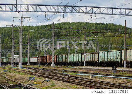 Freight trains traveling on tracks that are completely surrounded by beautiful nature Freight trains traveling on tracks that are completely surrounded by beautiful nature 131327915