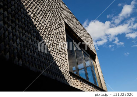 Modern Architectural Facade Featuring Unique Textures and Beautiful Natural Lighting Elements Modern Architectural Facade Featuring Unique Textures and Beautiful Natural Lighting Elements 131328020