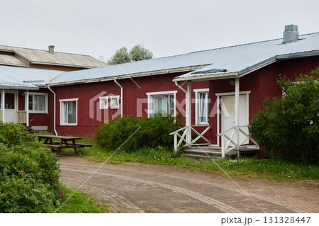 A Charming Red Wooden House Surrounded by Beautiful Lush Greenery and Natures Beauty 131328447
