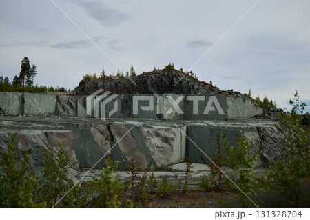 Explore a Scenic Quarry Landscape filled with Majestic Natural Stone Formations all around you Explore a Scenic Quarry Landscape filled with Majestic Natural Stone Formations all around you 131328704
