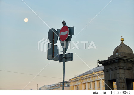 A traffic sign featuring a moon and a pigeon set against an urban background environment 131329067