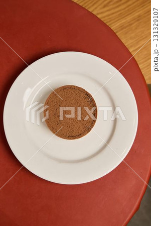 A Single Delicious Cookie is Beautifully Plated on a White Plate for Maximum Effect 131329107