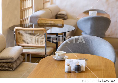 A Contemporary Cafe Interior Featuring Cozy Seating Arrangements for an Inviting Atmosphere 131329182