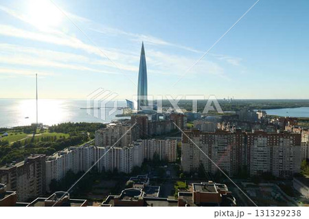 A stunning modern cityscape featuring a striking skyscraper positioned beautifully near the water 131329238