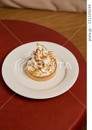 A Delicious and Tempting Meringue Tarte Beautifully Presented on a Plate for Enjoyment A Delicious and Tempting Meringue Tarte Beautifully Presented on a Plate for Enjoyment 131329244