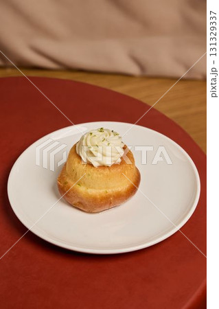 A Delicious and CreamTopped Dessert Beautifully Presented on a Plate for All to Enjoy 131329337