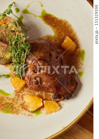 Gourmet Display of Succulent, Savory Meat Accompanied by Citrus Fruits and Aromatic Herbs Gourmet Display of Succulent, Savory Meat Accompanied by Citrus Fruits and Aromatic Herbs 131329398
