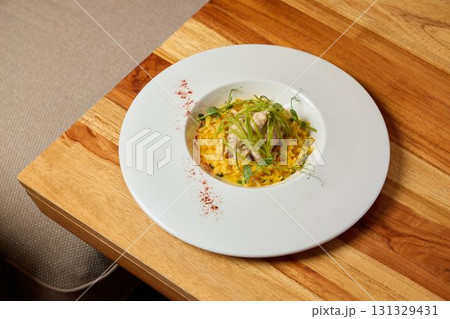 An Elegant and Beautiful Plate of a Gourmet Rice Dish prepared with Fresh and Flavorful Ingredients 131329431