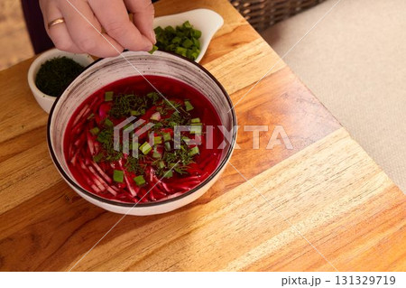 This vibrant beetroot soup, enriched with fresh herbs and green onions, is perfect for any meal This vibrant beetroot soup, enriched with fresh herbs and green onions, is perfect for any meal 131329719