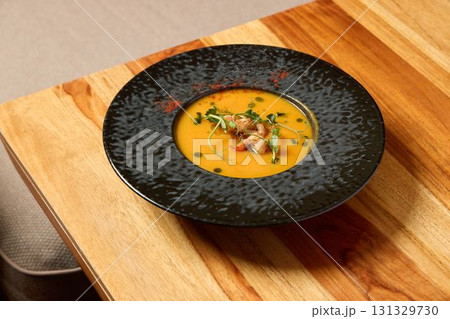 Delicious Gourmet Soup Served in a Beautifully Elegant Black Bowl for Your Dining Pleasure Delicious Gourmet Soup Served in a Beautifully Elegant Black Bowl for Your Dining Pleasure 131329730