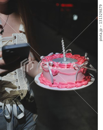 Joyful Pink Cake Celebration with a Mobile Phone, capturing moments with friends and desserts Joyful Pink Cake Celebration with a Mobile Phone, capturing moments with friends and desserts 131329879