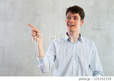 Portrait of young guy gesturing in studio 131332159
