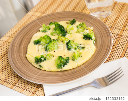 wholesome breakfast. omelet with broccoli on brown plate wholesome breakfast. omelet with broccoli on brown plate 131332162