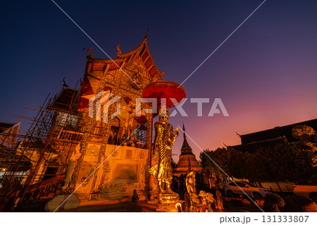 Time lapse In the evening, a golden Buddha and an ornate temple Time lapse In the evening, a golden Buddha and an ornate temple 131333807